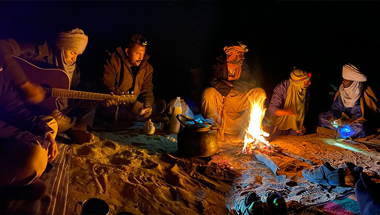 Pause nocturne au coin du feu après une longue marche initiatique dans le désert Algérien